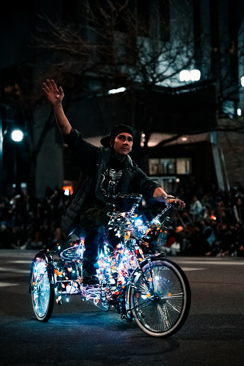 a man riding a bike with a lot of lights on it