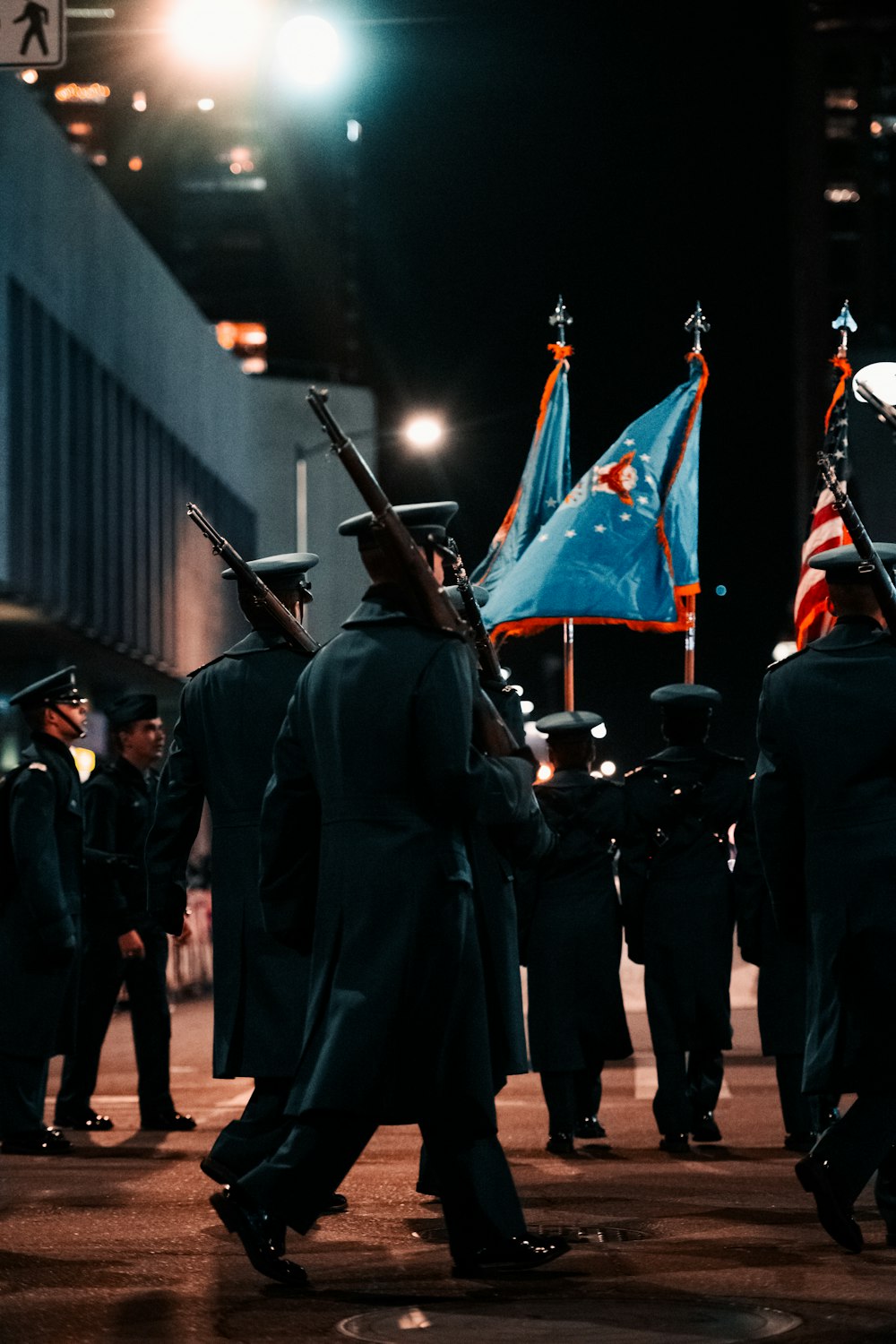 a group of men in uniform marching down a street
