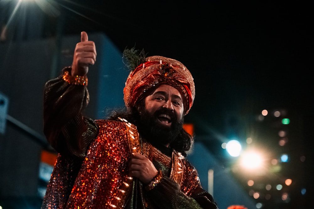 a man in a turban giving a thumbs up