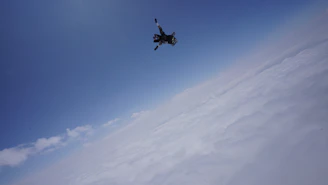 A vibrant skydiver in freefall against a bright blue sky, with a subtle overlay of an altimeter graphic.