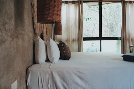 a bedroom with a large bed and a window