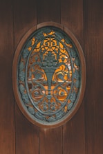 a wooden door with a decorative metal design