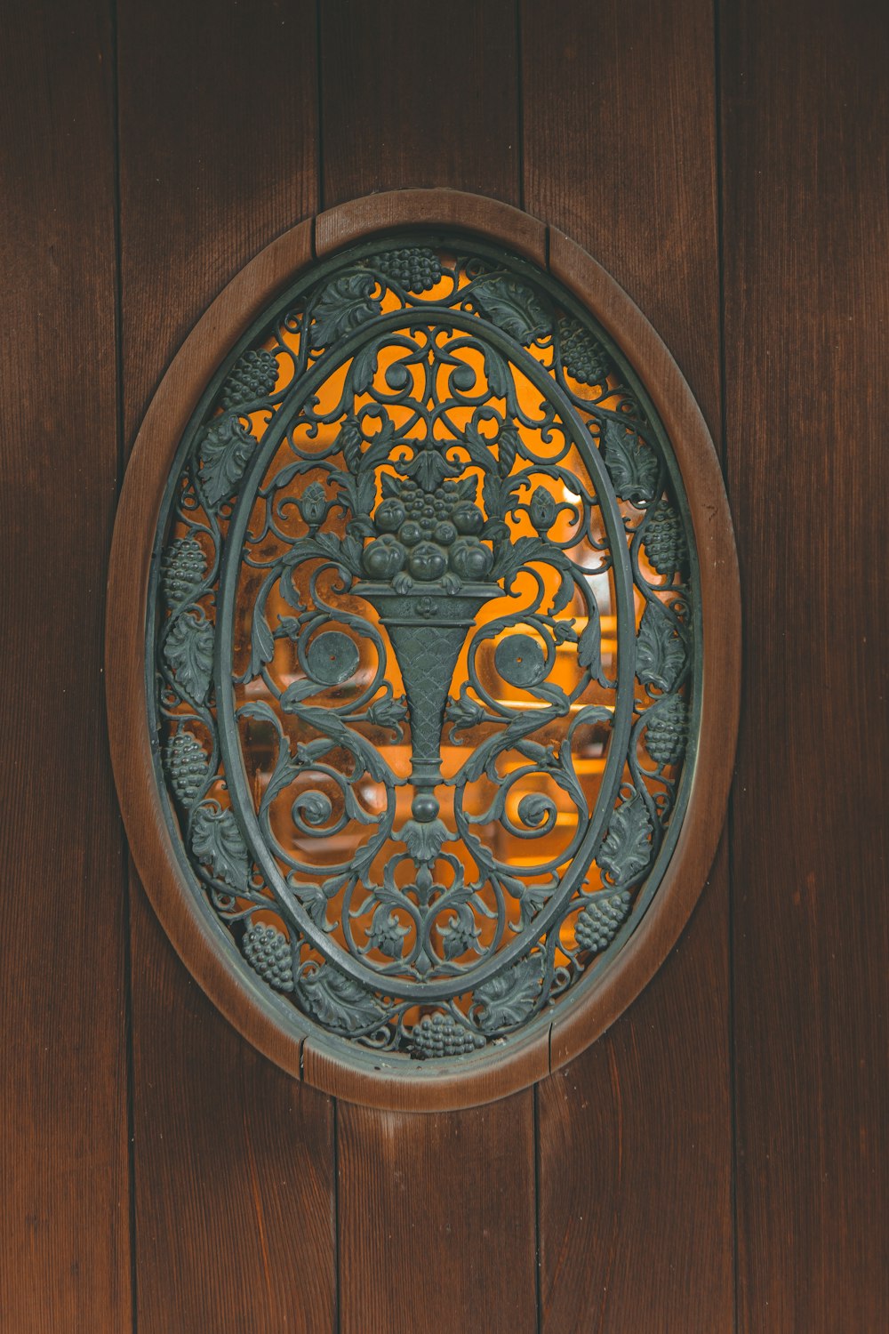 a wooden door with a decorative metal design