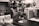 A busy kitchen with workers preparing tortillas and using machinery.