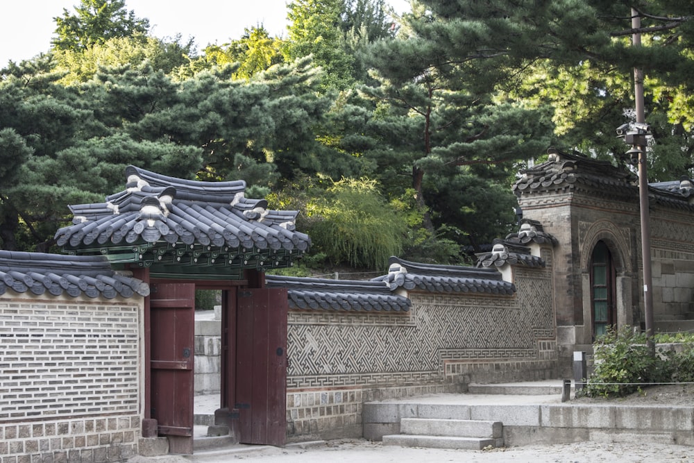 a building with a gate and steps leading to it