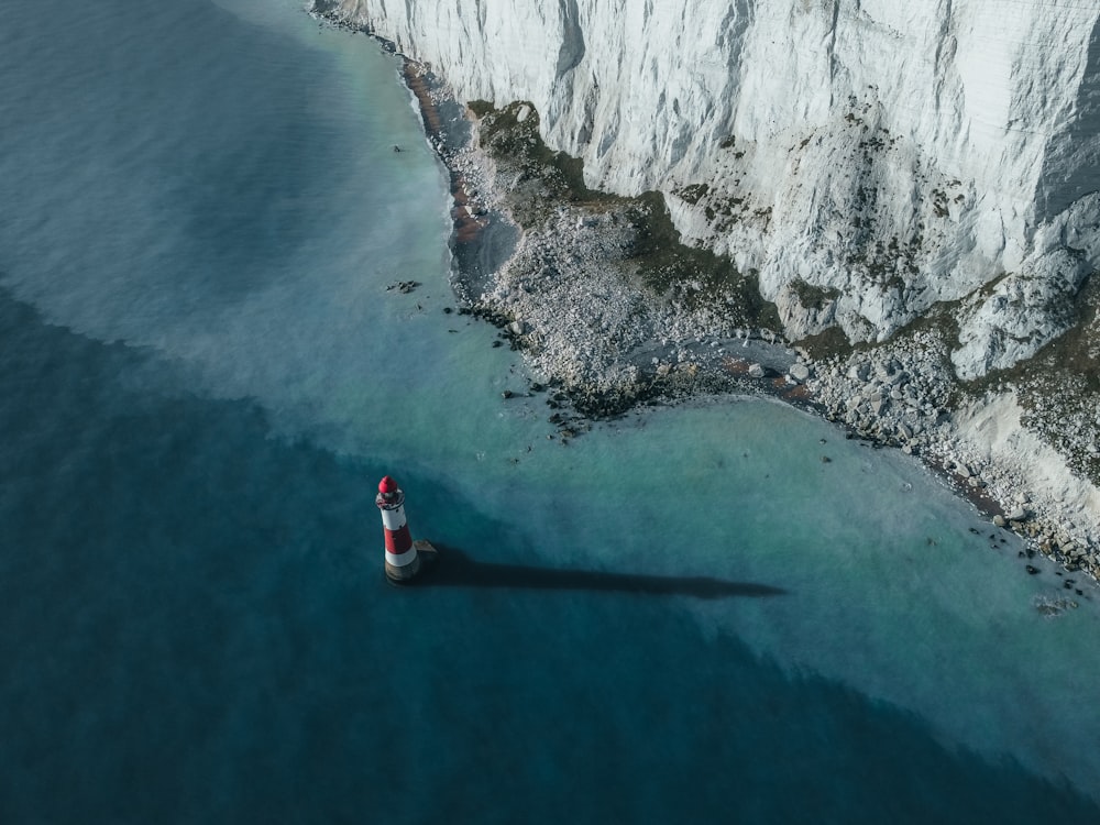 an aerial view of a lighthouse on the coast