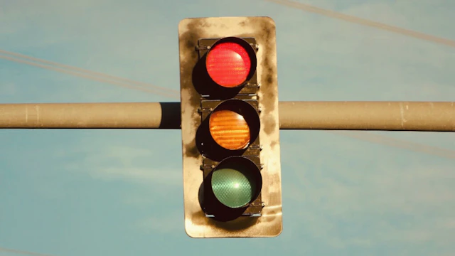 a traffic light hanging from a metal pole
