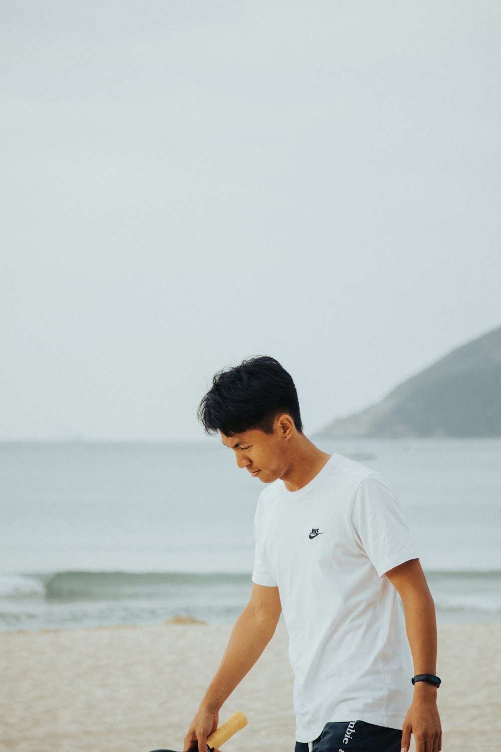 a man holding a surfboard on a beach