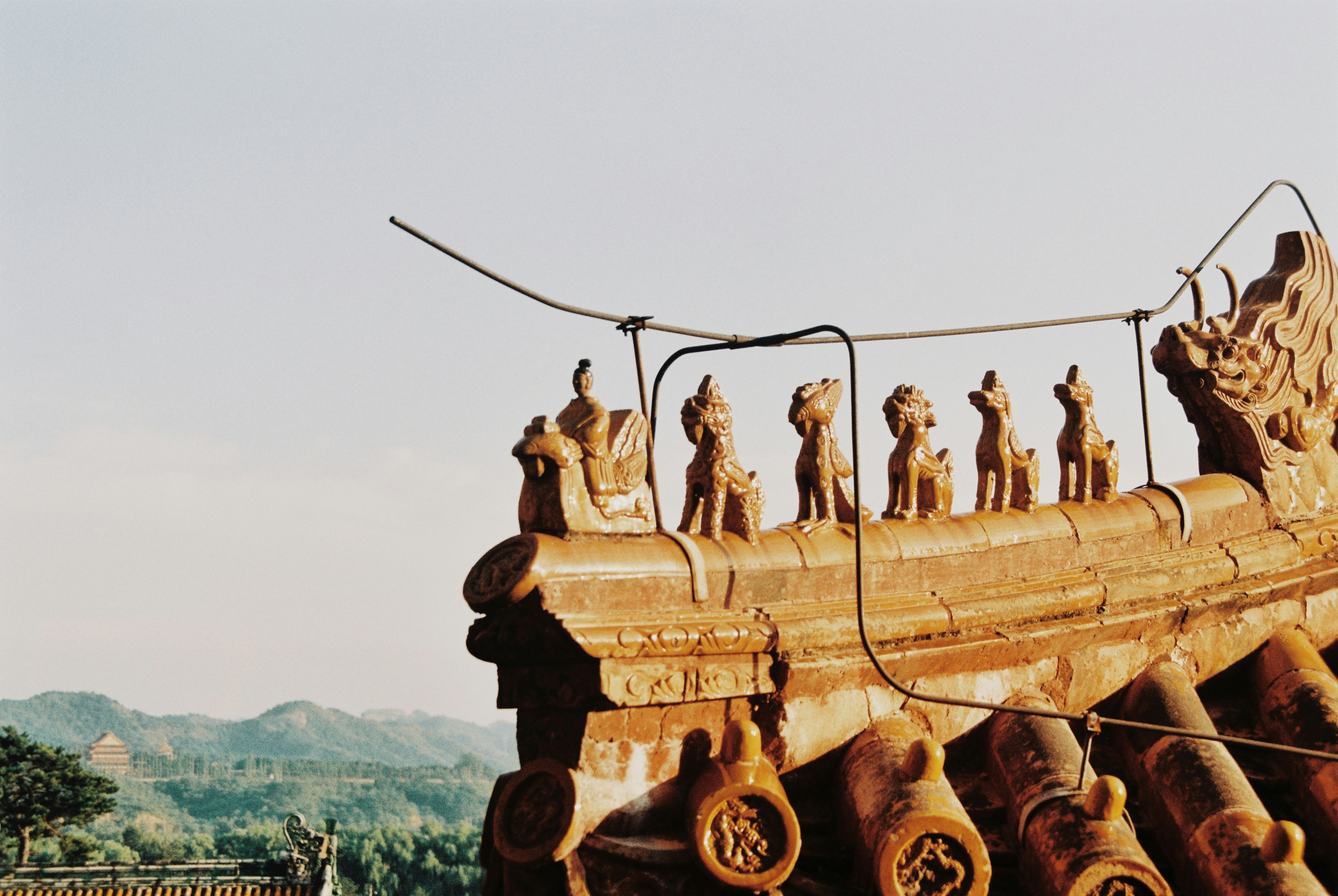 a wooden boat with statues on top of it