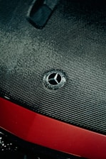 Close-up of a car with a carbon fiber hood wrap.