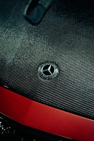 Close-up of a custom carbon fiber hood on a Corvette C8, highlighting the flawless finish and intricate weave.