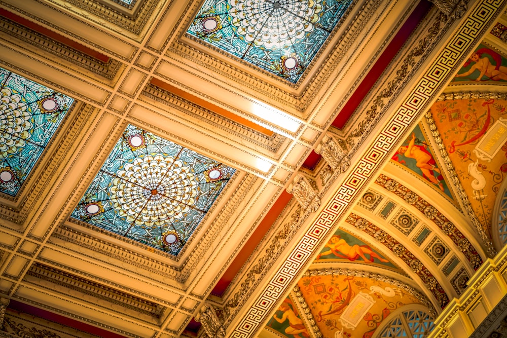 the ceiling of a building with stained glass windows