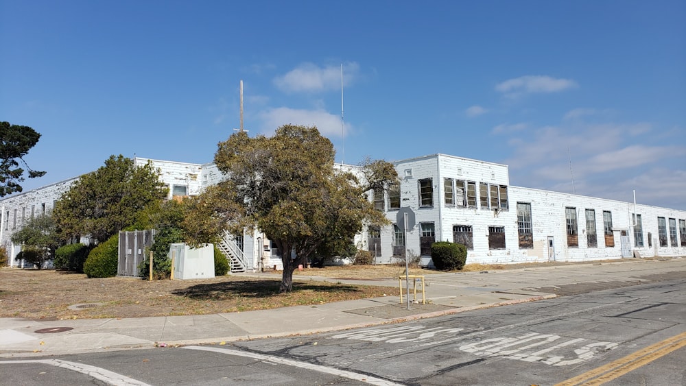 a large white building sitting on the side of a road