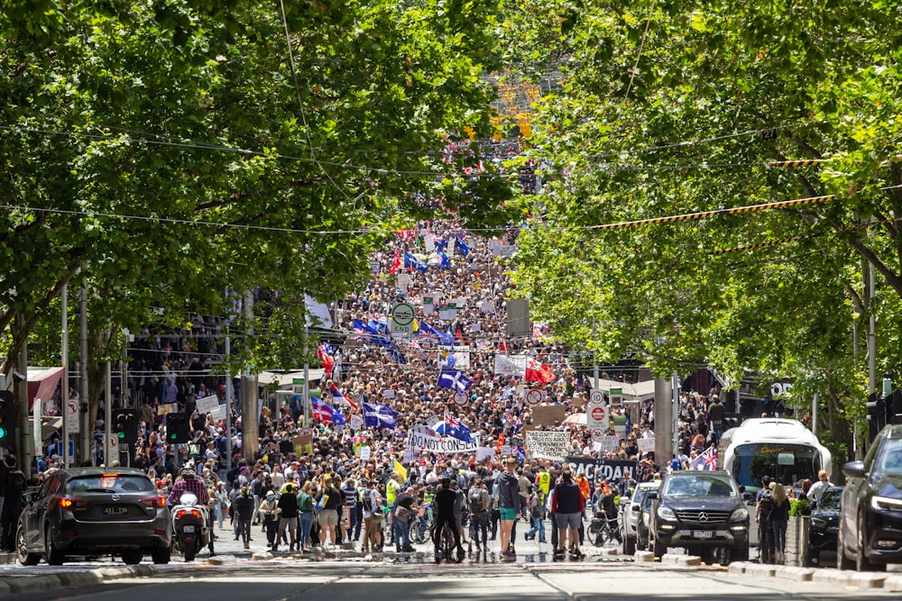 a large crowd of people walking down a street