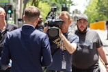 Close-up of a local news reporter interviewing a person on the street.
