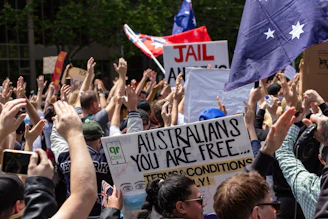 A happy family holding Australian flags, celebrating their successful migration.