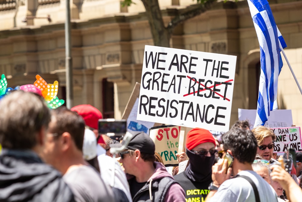 a group of people holding signs and flags