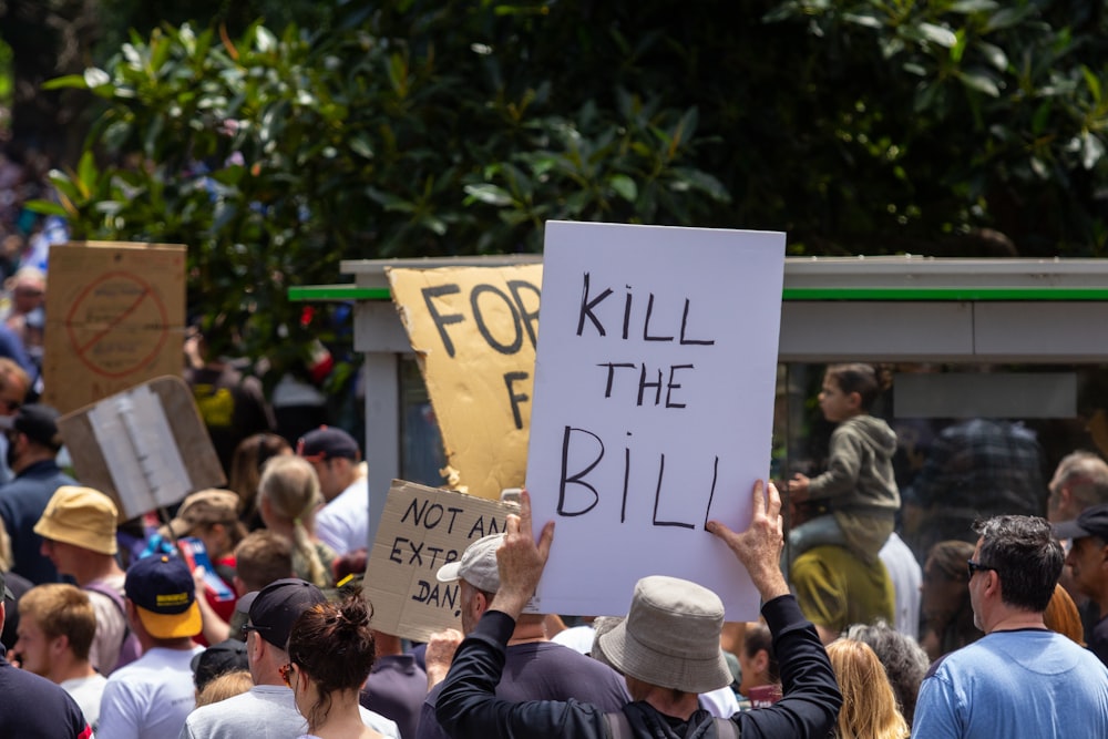 a group of people holding signs in the air