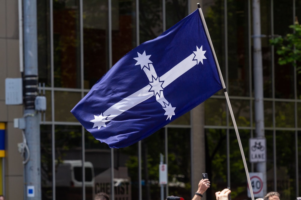 a group of people holding a flag and a cell phone