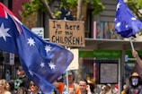 a group of people holding flags and signs