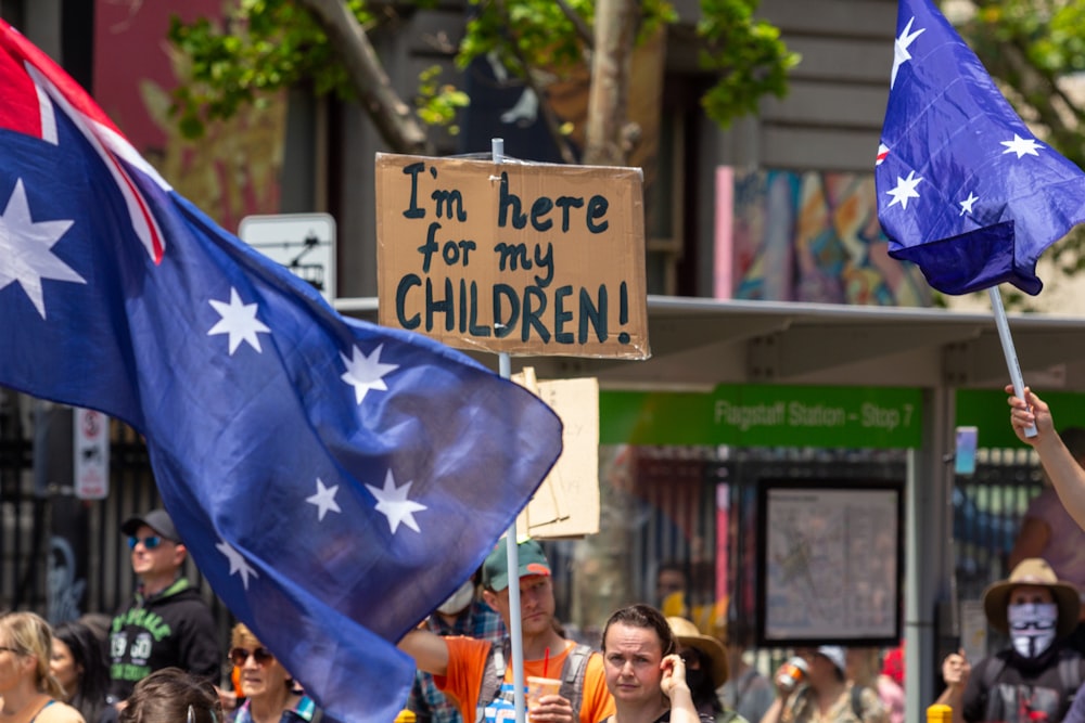 a group of people holding flags and signs