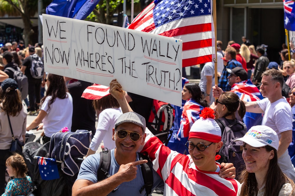 a group of people holding signs and flags