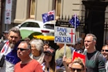 a crowd of people holding signs and flags