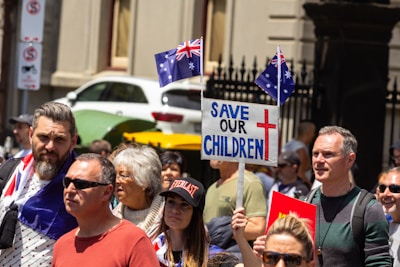 a crowd of people holding signs and flags