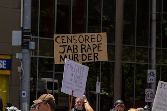 a group of people holding up signs in the street