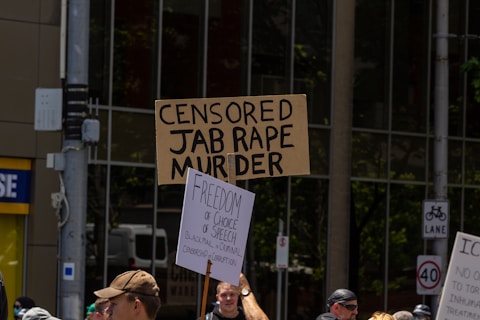 a group of people holding up signs in the street