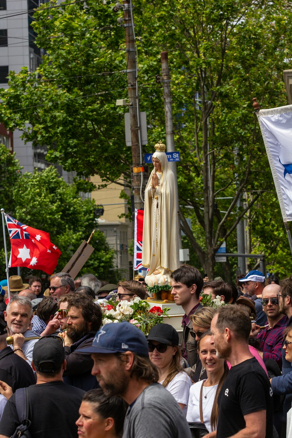 a crowd of people standing around a statue