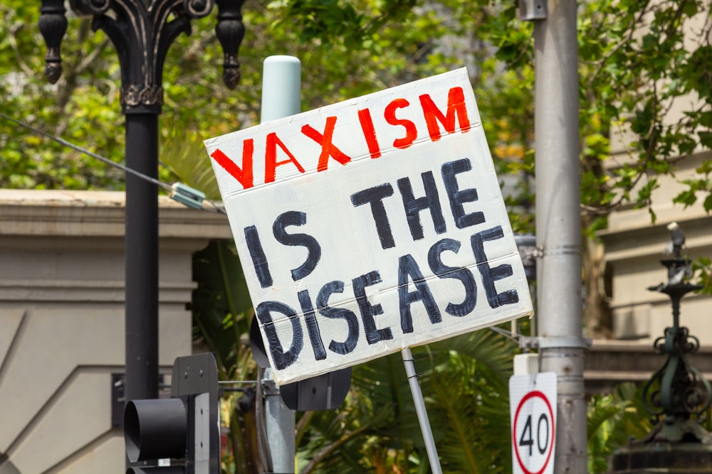 a sign that says waxism is the disease