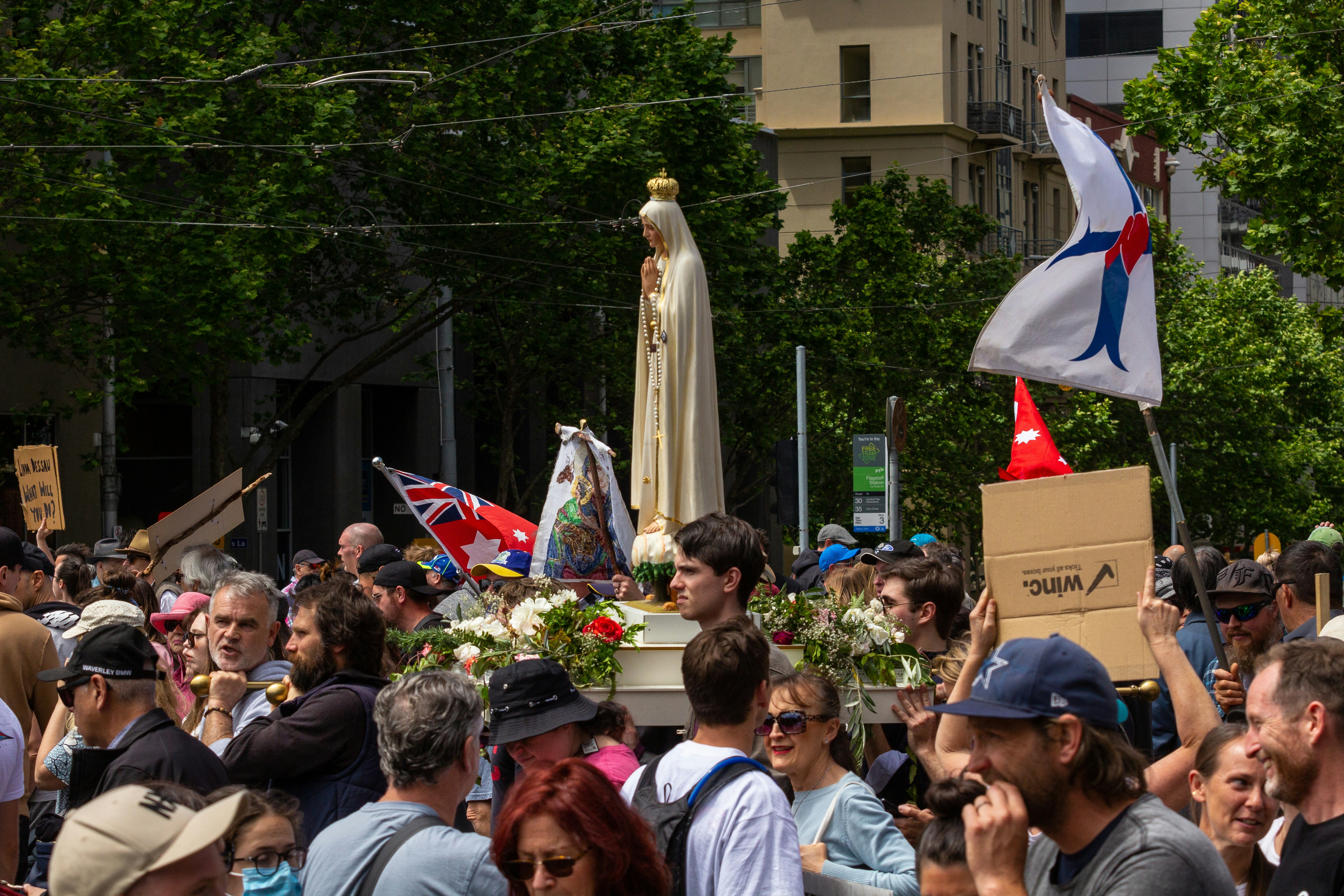 a crowd of people standing around a statue