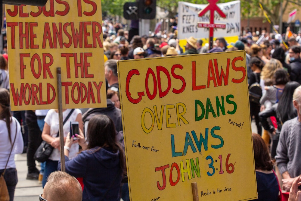 a group of people holding signs in a protest