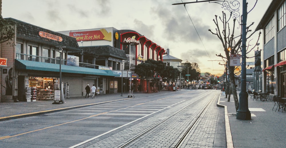 a city street with a train track running through it