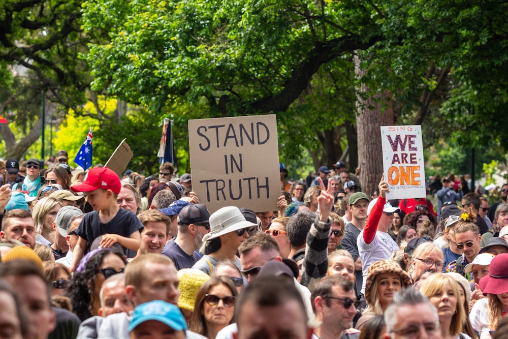 a large crowd of people with signs and hats