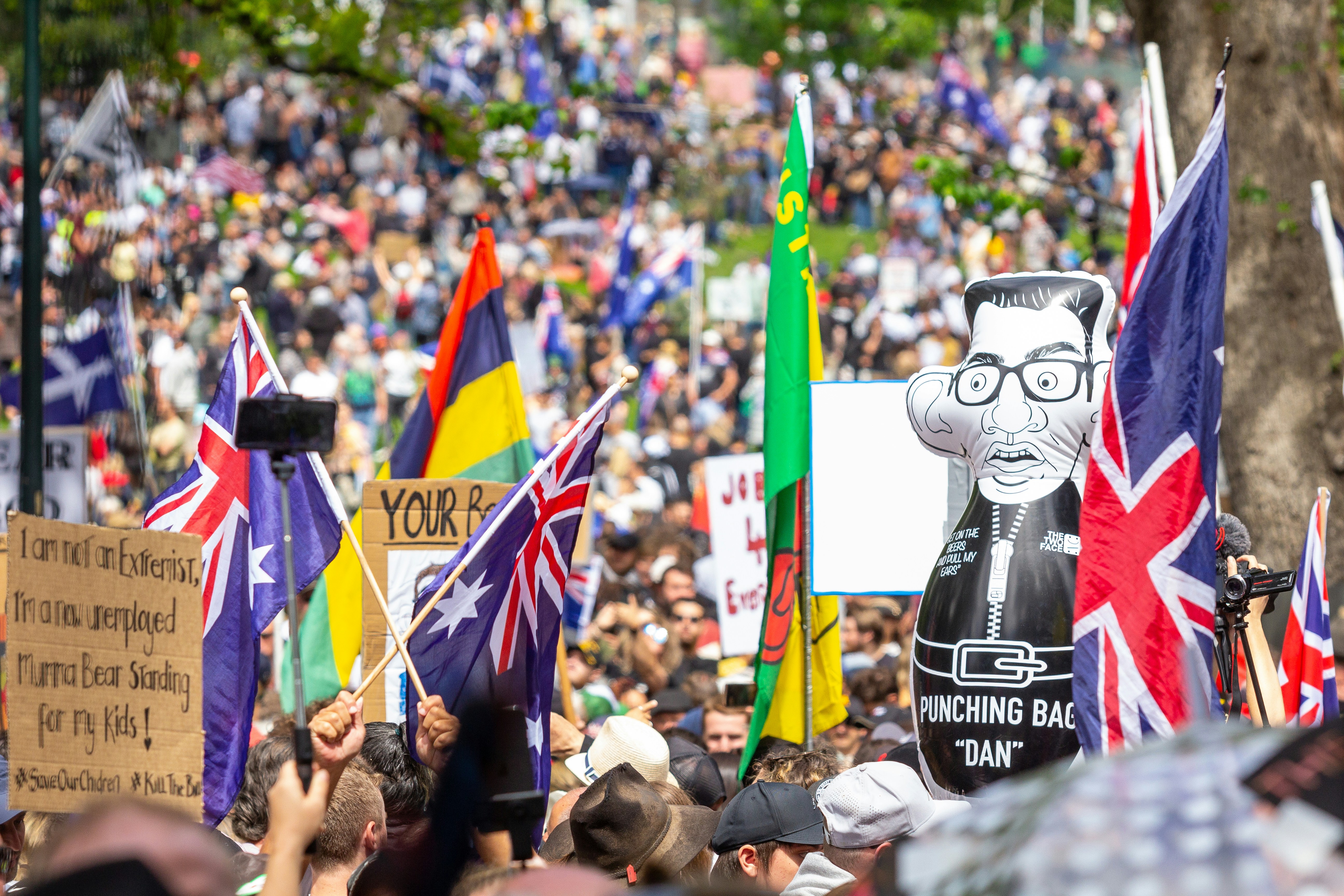 Melbourne's Freedom protests rally and march in the city November 20th 2021 - over 200,000 people marched from Parliament to the Flagstaff Gardens. A happy family friendly crowd singing and chanting \