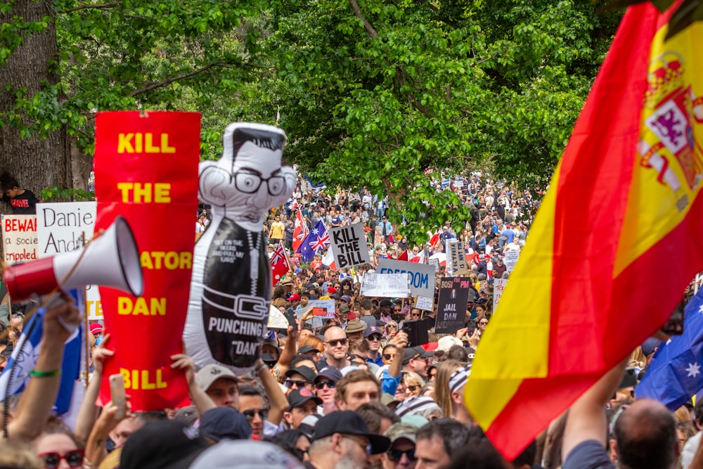 a large group of people holding flags and banners