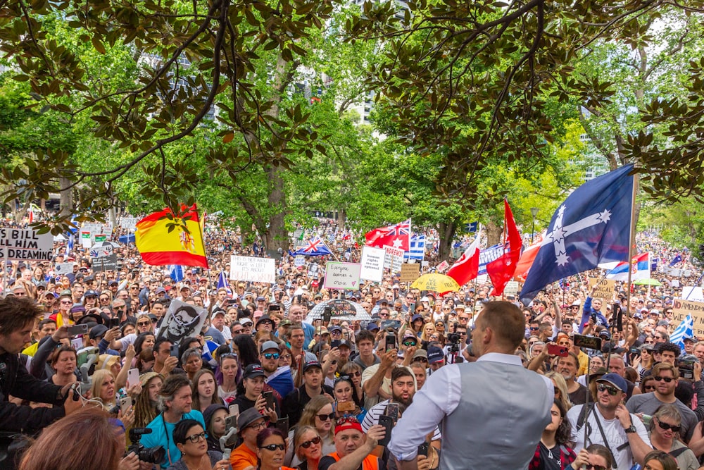 a large crowd of people standing around each other