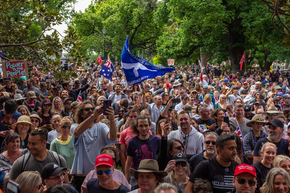 a large group of people standing in a park