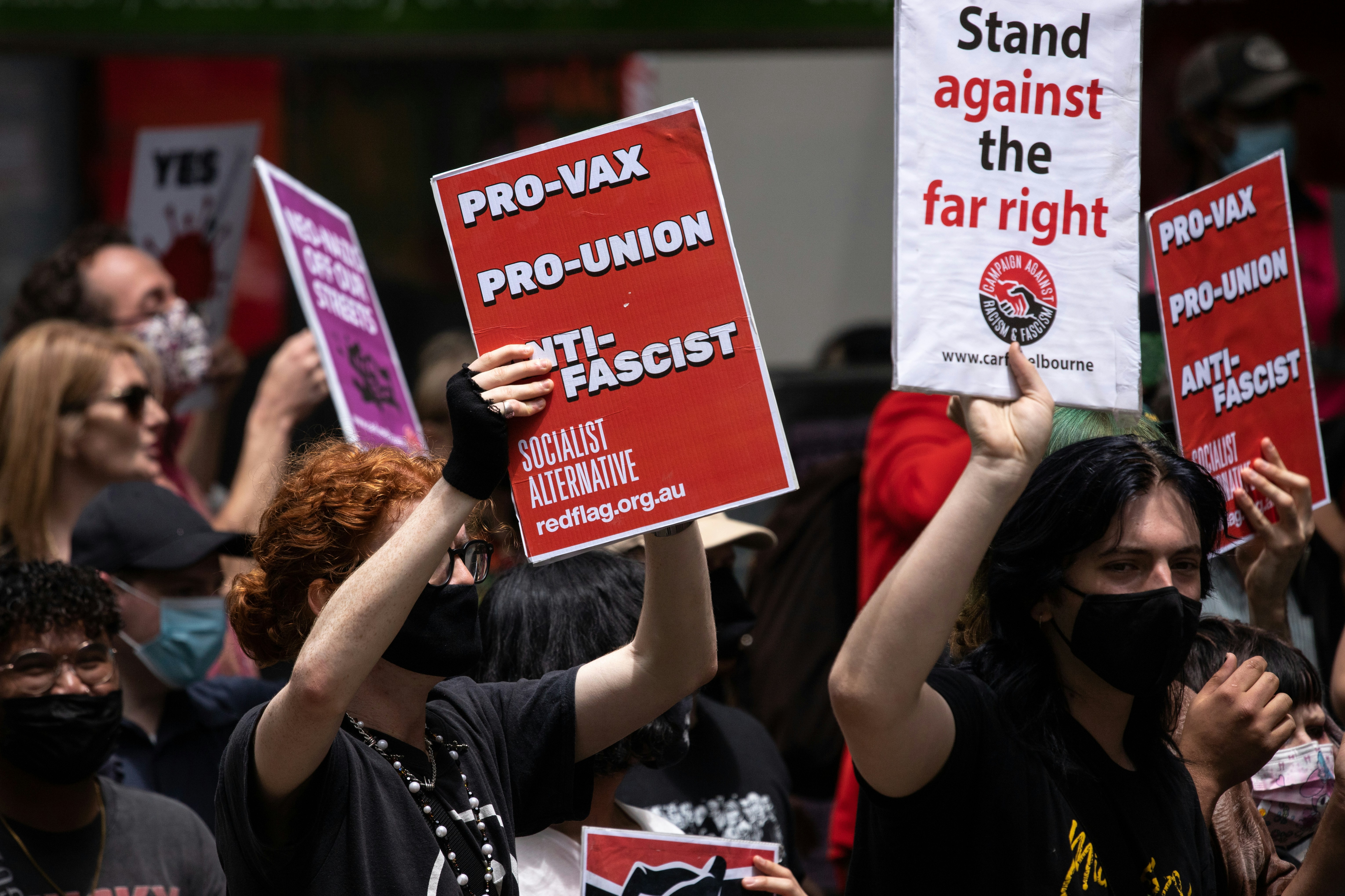 a group of people holding up signs in the air