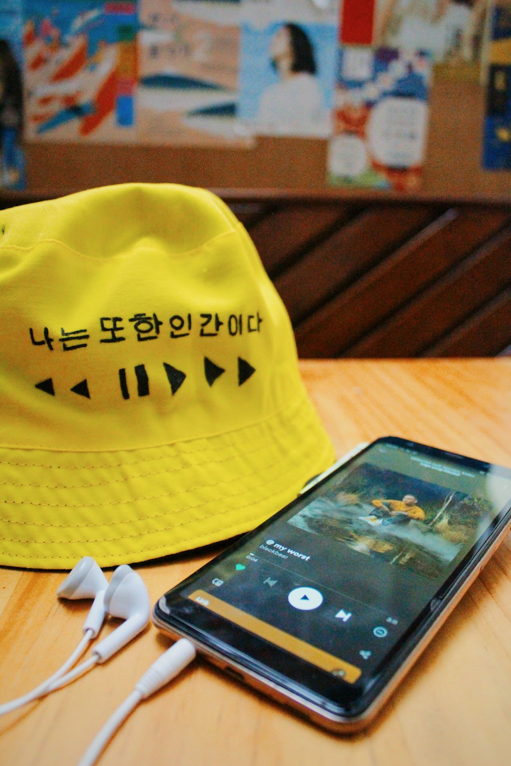 a cell phone sitting next to a yellow hat