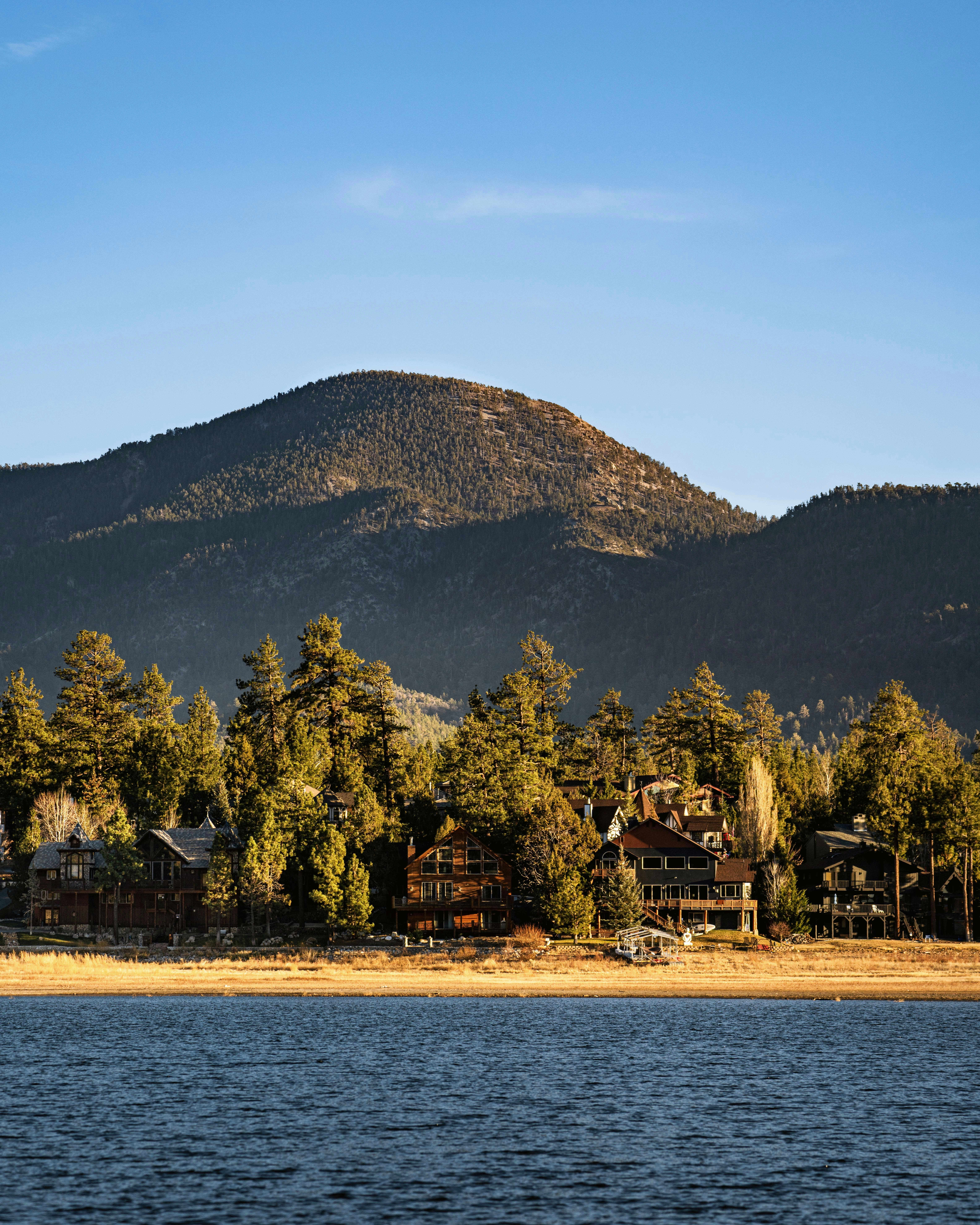 a large body of water with a mountain in the background