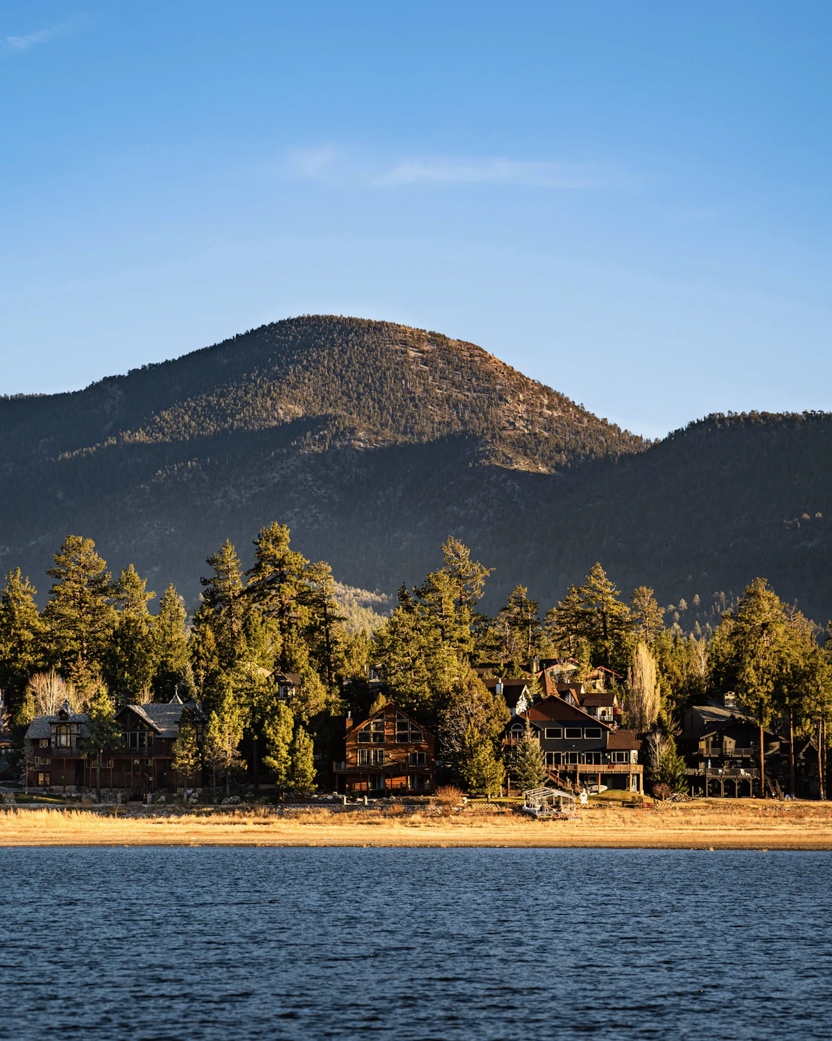 Wooden cabin by a mountain lake