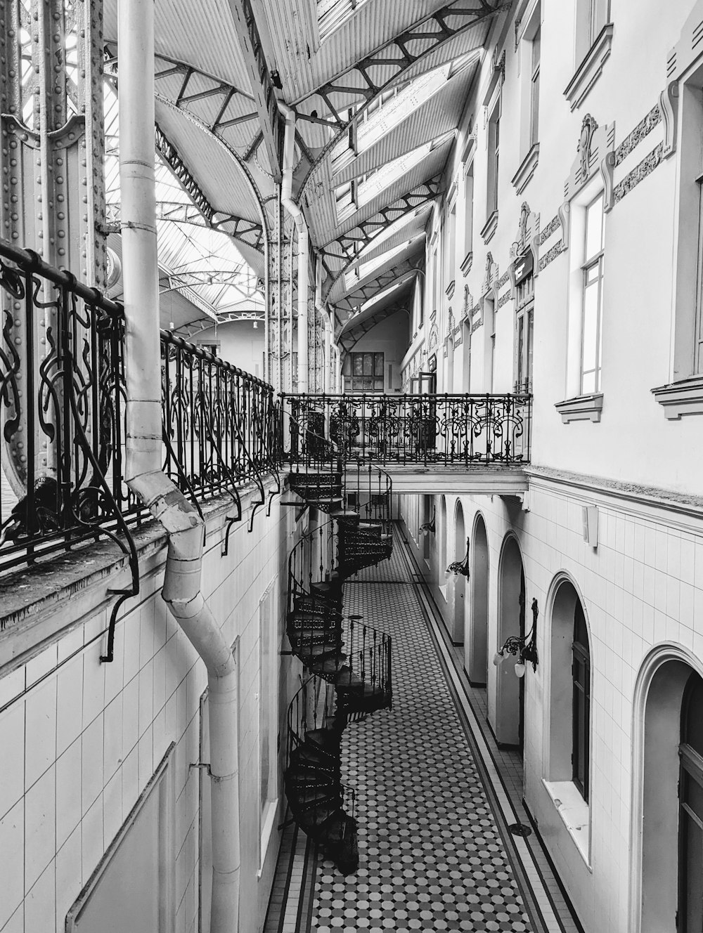 a black and white photo of a long hallway