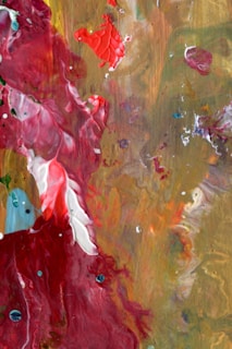 A vibrant painting created with red wine, showing swirling colors and poetic brushstrokes.