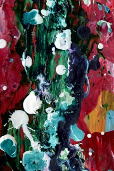 A colorful acrylic painting featuring abstract shapes and textures on a canvas.