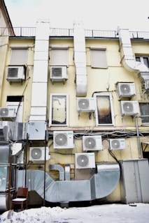 a building that has a bunch of air conditioners on it