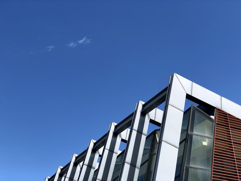 a plane flying in the sky over a building