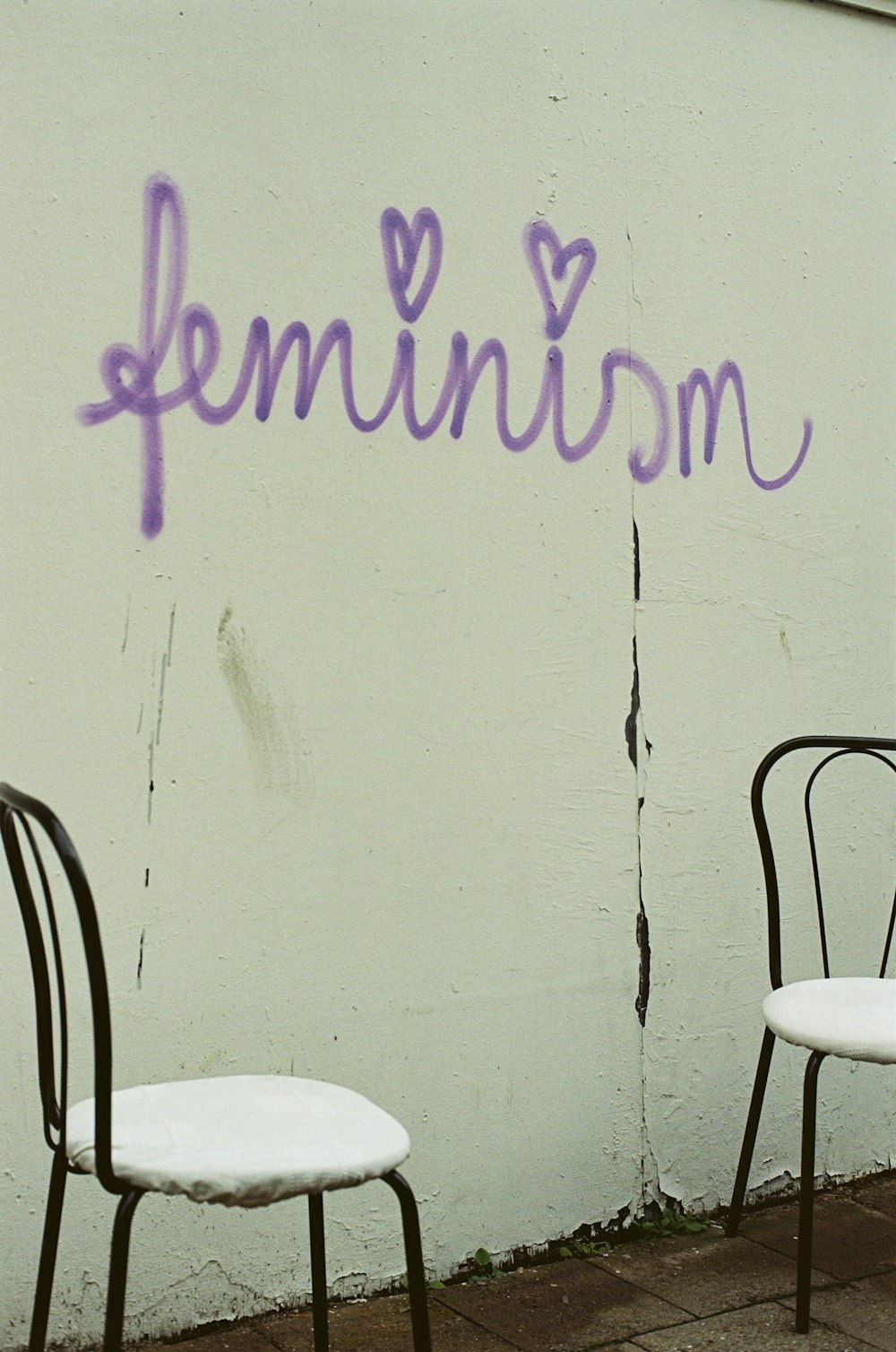 a couple of chairs sitting next to a wall